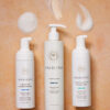 Tre flasker Innersense i Create Lift Volumizing Foam - Styling 177 ml på en solbrun baggrund.
